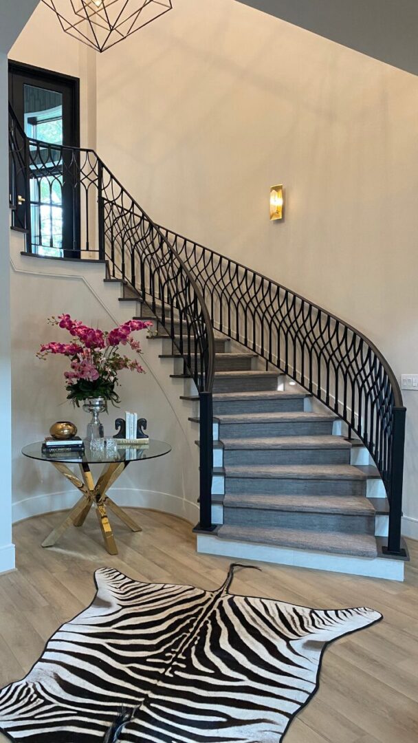 Wild design with zebra rug and iron stair by Aurora Fain